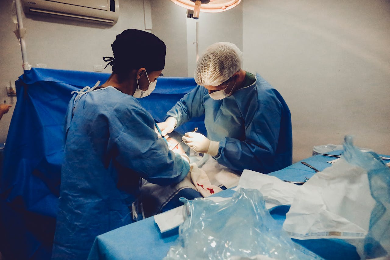 Surgeons focusing on a procedure in an equipped operating room, showcasing teamwork and precision.